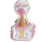 Baby bib and hat set with 'My first Birthday' text in a store setting