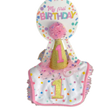 Baby bib and hat set with 'My first Birthday' text in a store setting