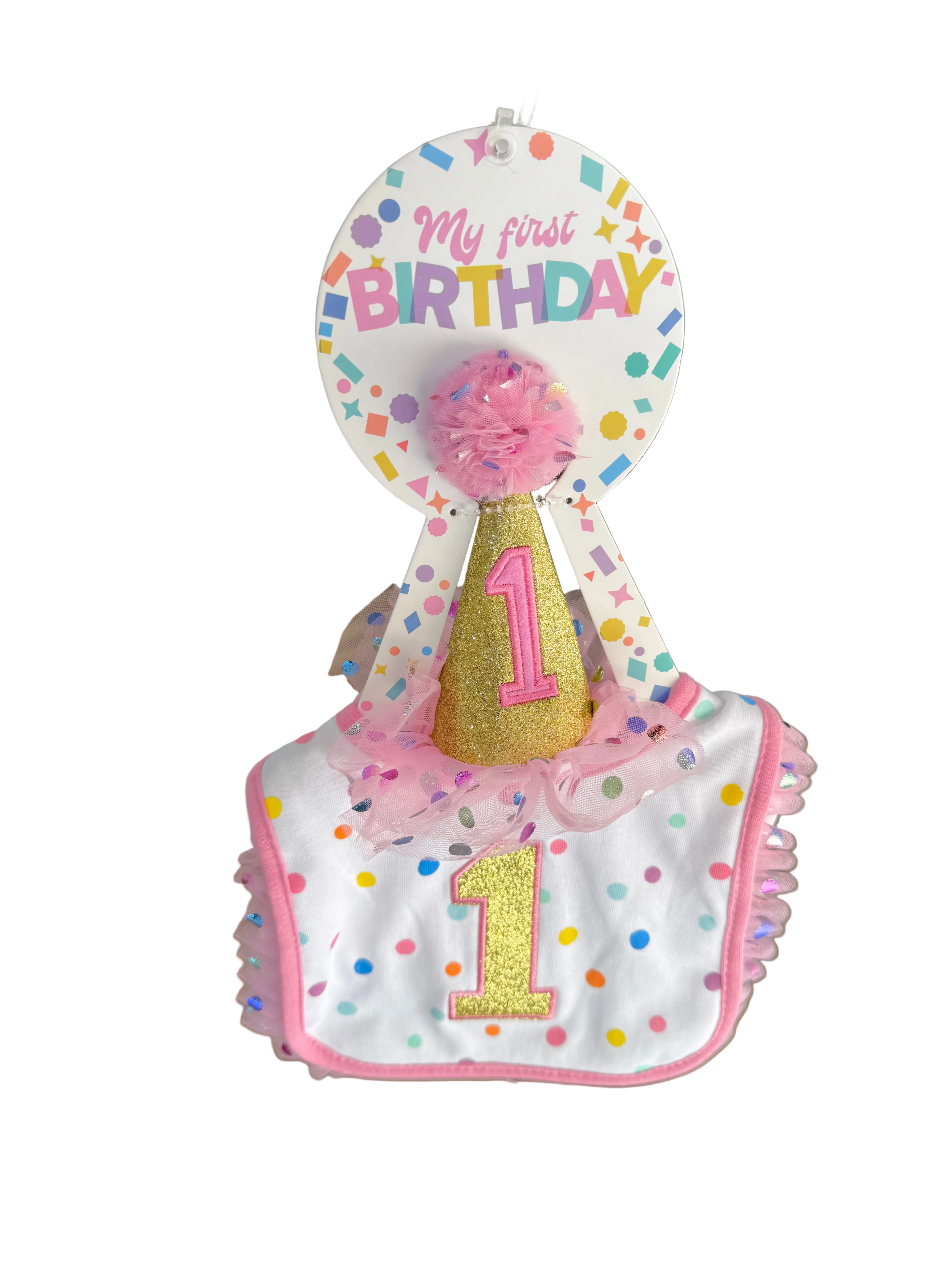 Baby bib and hat set with 'My first Birthday' text in a store setting