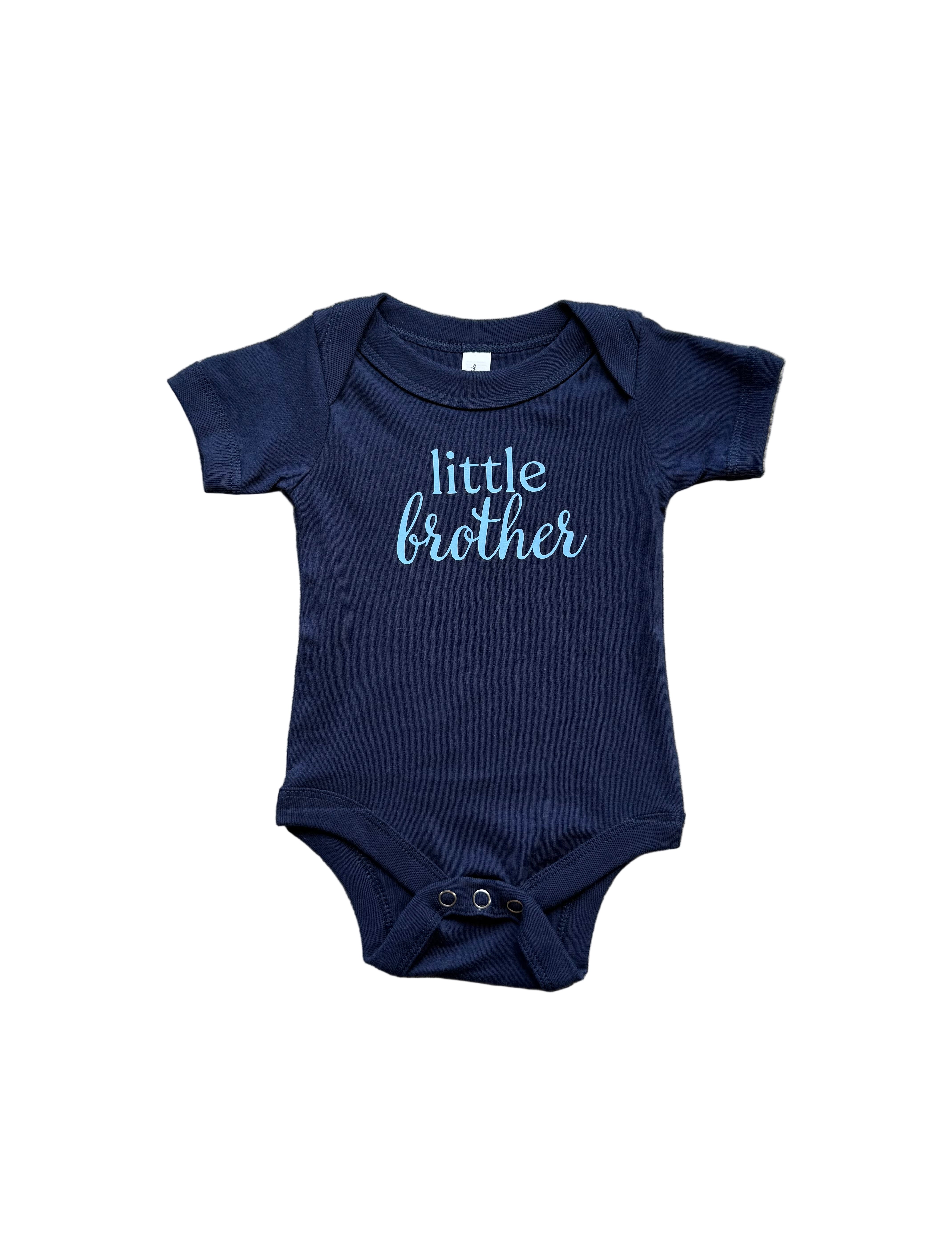 Navy blue baby onesie with 'little brother' text on a textured surface