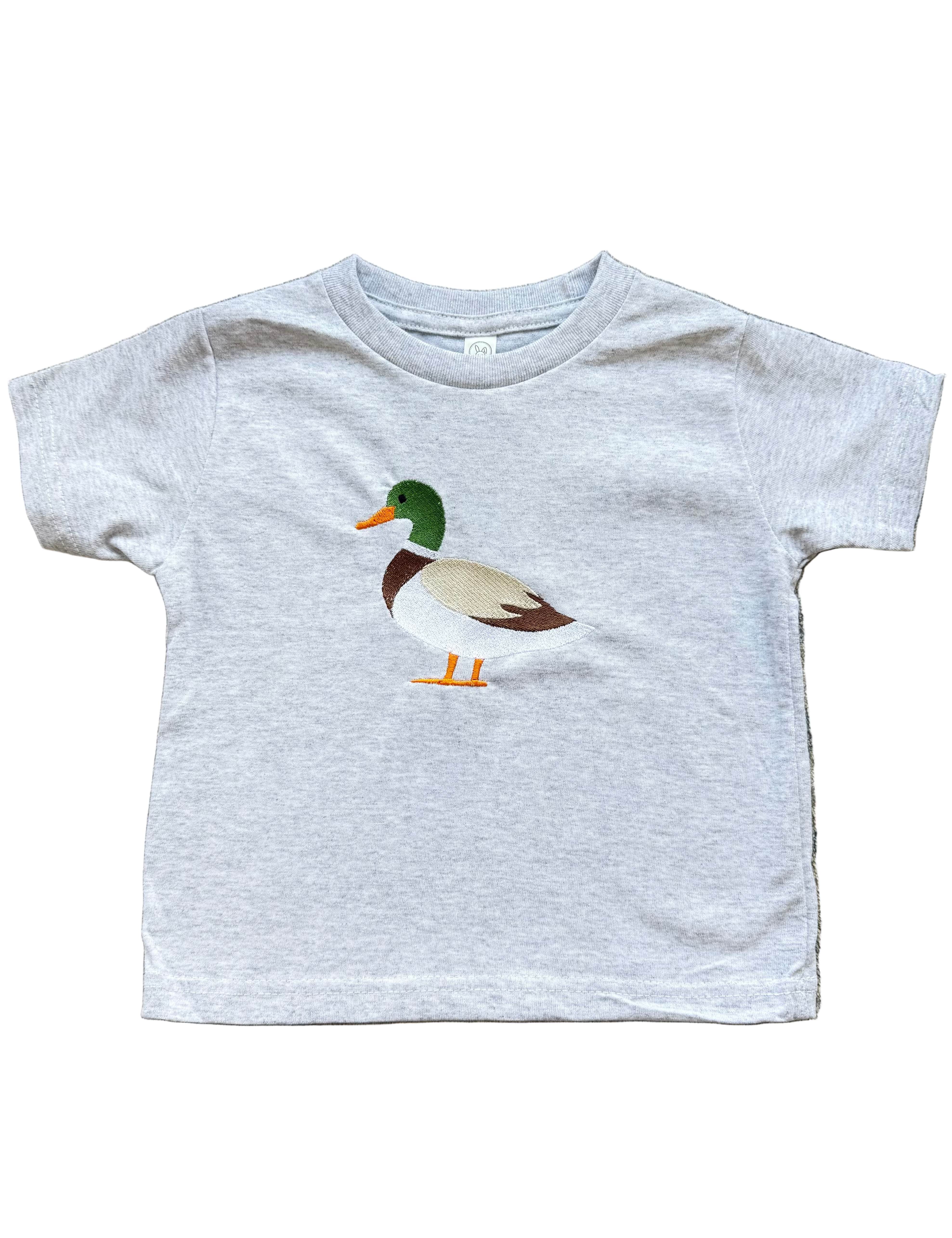 Gray t-shirt with a duck graphic on a textured surface