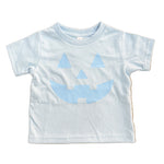 light blue kids  t-shirt with blue jack-o'-lantern design on a wooden floor