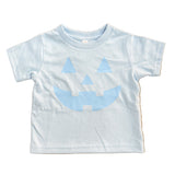 light blue kids  t-shirt with blue jack-o'-lantern design on a wooden floor