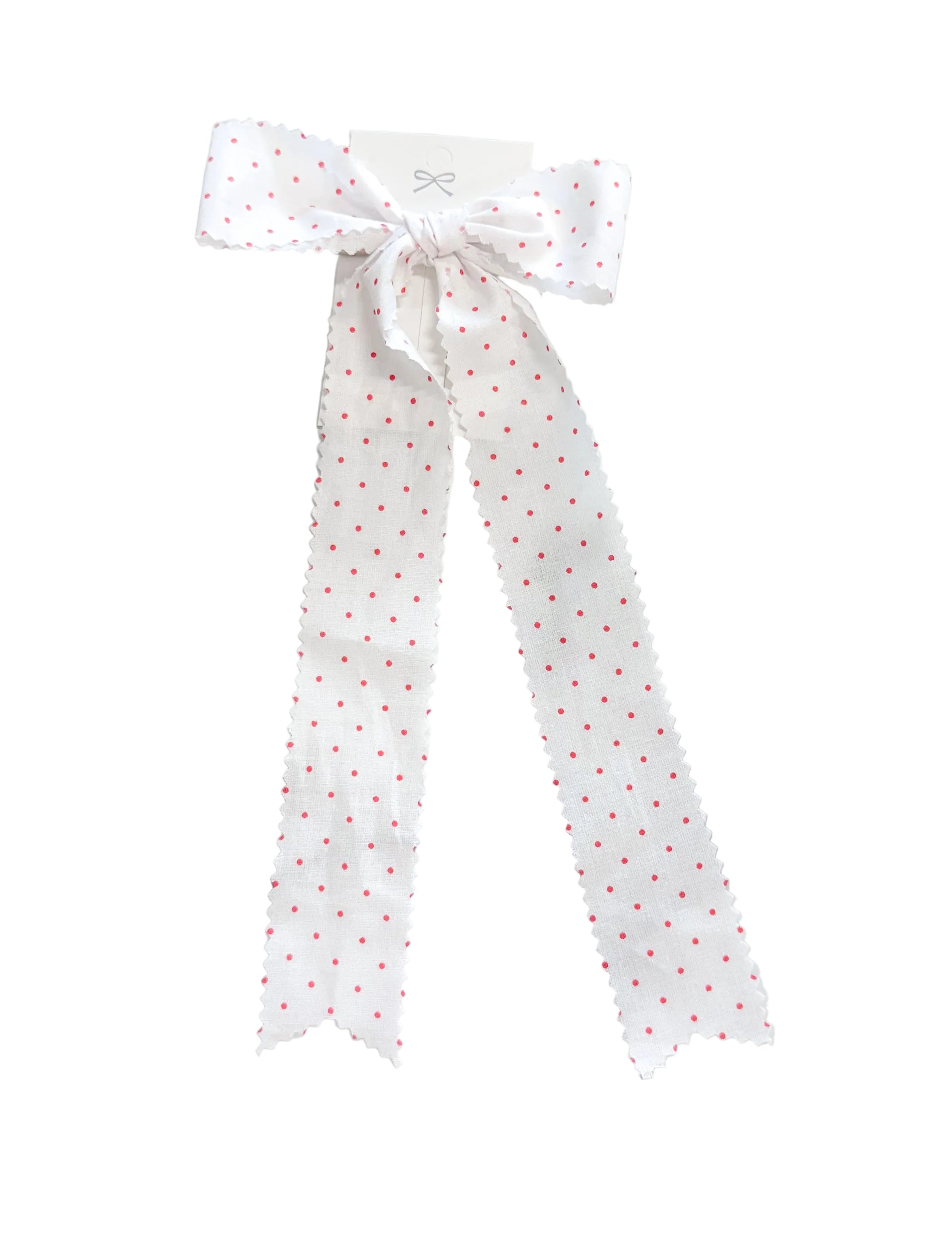 Polka dot ribbon tied in a bow on a marble surface