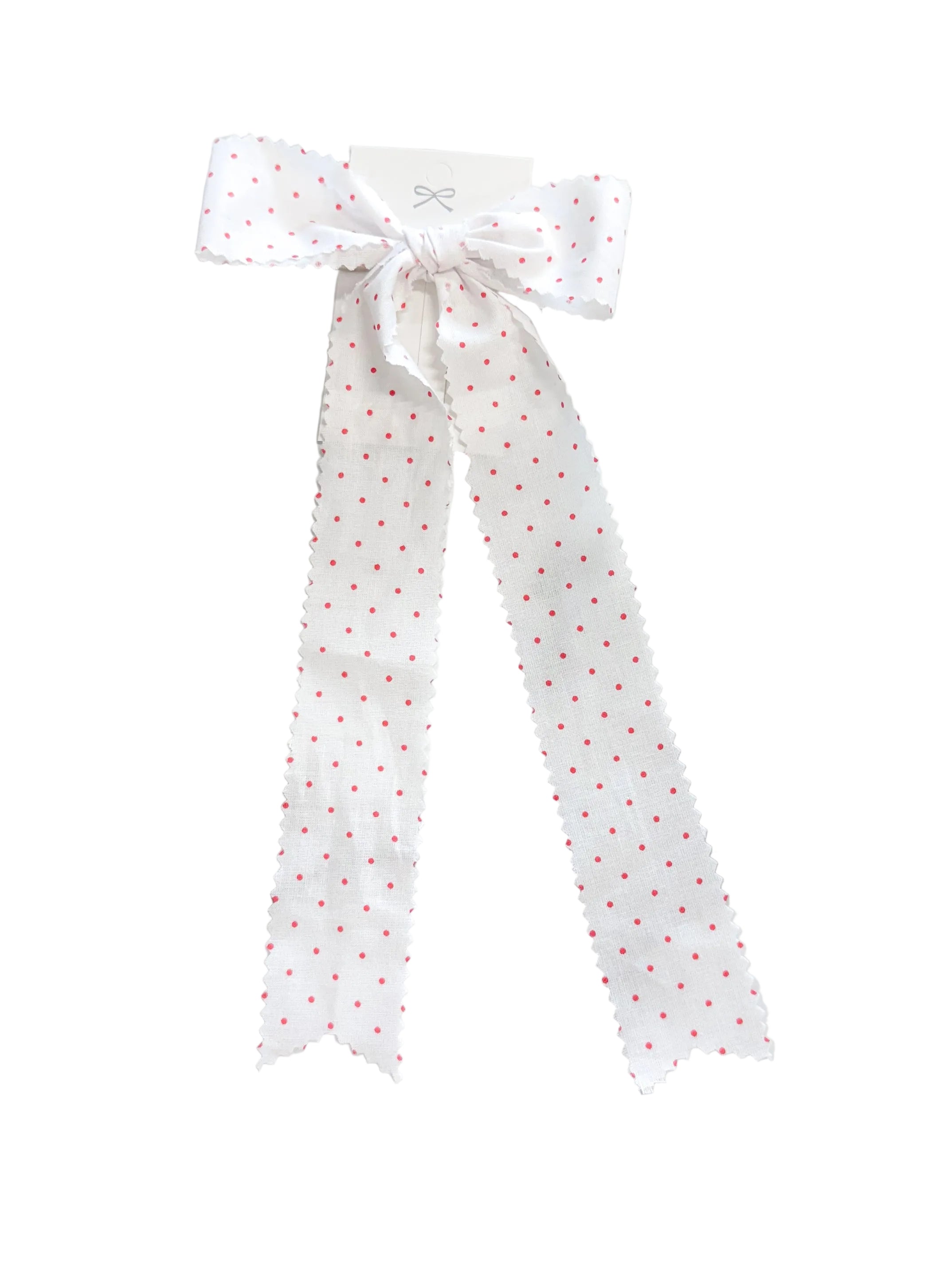 Polka dot ribbon tied in a bow on a marble surface