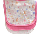 Baby bib with colorful patterns held up in a store setting