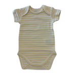 Yellow and white striped baby onesie on a marble surface